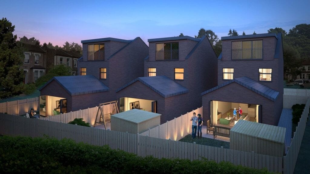 Twilight view of a contemporary backland development featuring red brick houses with illuminated interiors and people enjoying the communal outdoor spaces, set against a backdrop of a serene neighborhood.