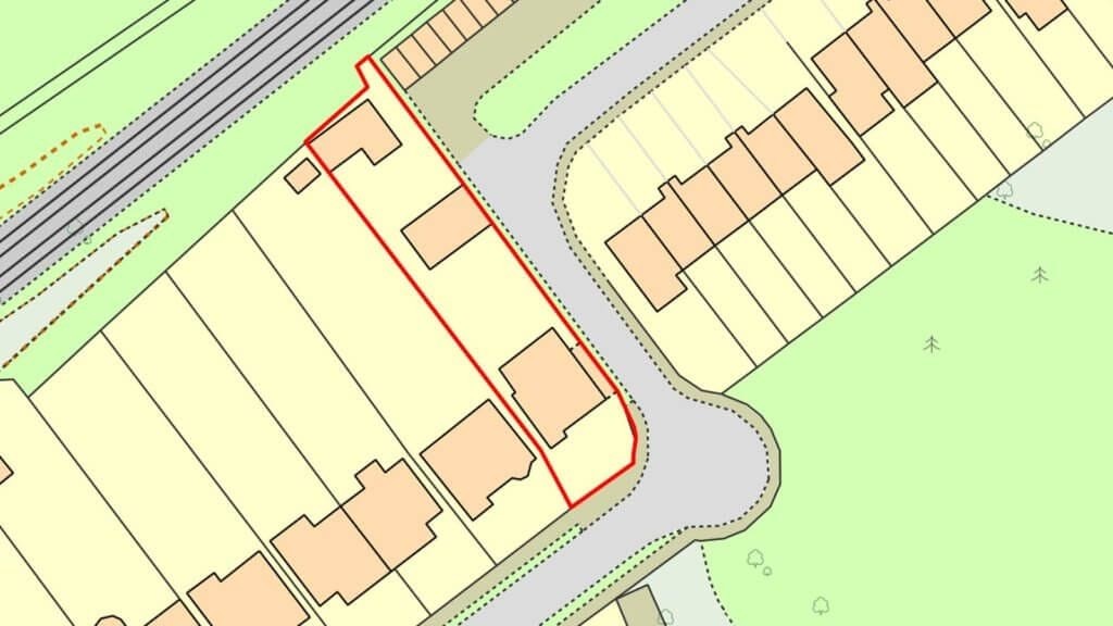 Site plan highlighting a potential backland development area outlined in red, adjacent to a curved road with existing houses, providing a visual for urban planning and land use strategy.