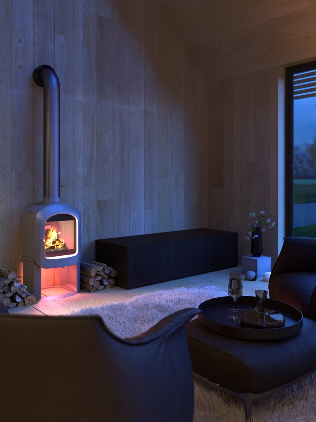 Intimate corner of a barn conversion at dusk, featuring a modern freestanding wood-burning stove, plush black seating, and a shaggy white rug, with two wine glasses on a tray, offering a romantic and cosy atmosphere.
