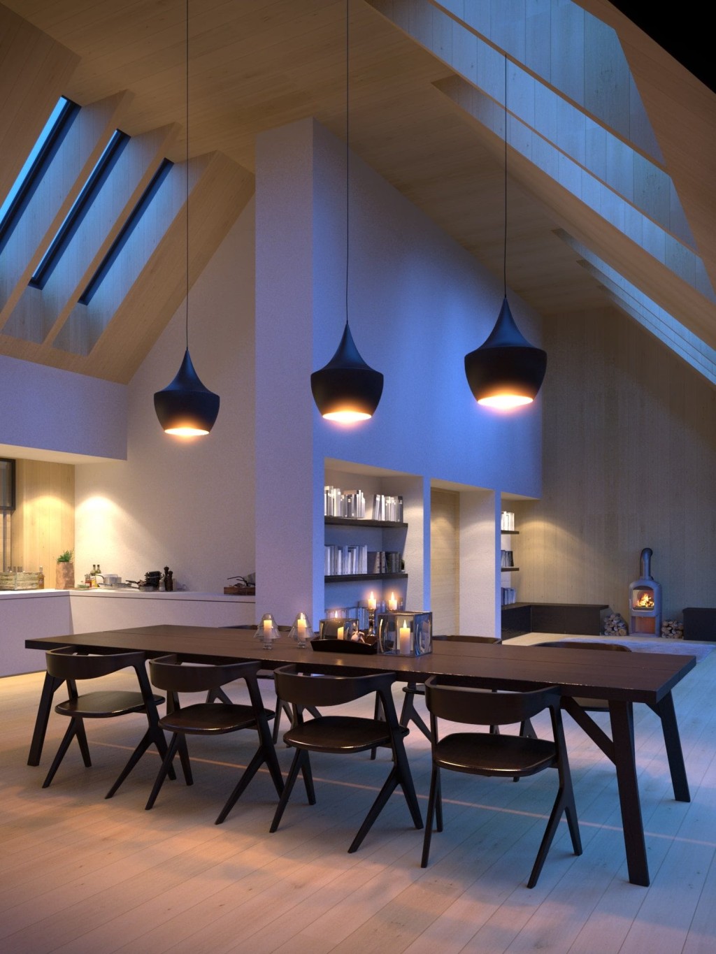 Contemporary dining area in a barn conversion illuminated by stylish pendant lights, featuring an elegant dark wooden table with matching chairs, built-in bookshelves, and a wood stove, set against a backdrop of light wooden walls and angled skylights.