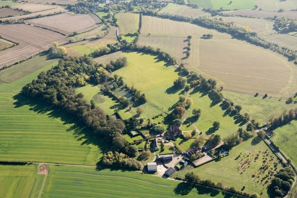 Aerial view of expansive Green Belt and agricultural land in the UK, showcasing potential sites for building new homes.