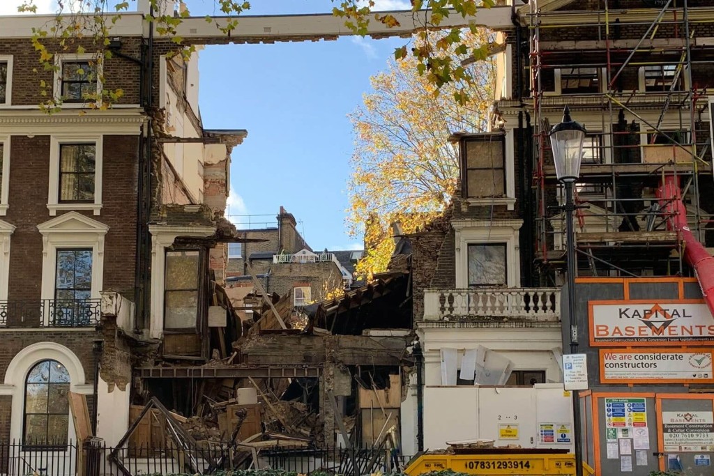 Collapsed section of a building in London due to poor temporary works during refurbishment. The image highlights the importance of proper structural support and safety measures in construction projects to prevent structural failures and ensure safety compliance.