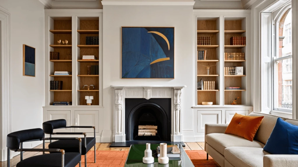 Elegantly restored living room interior of a Grade 2 listed building in Belgravia, featuring a white ornate fireplace, bespoke joinery with oak shelving, and a blend of modern and classic furnishings including a neutral-toned sofa with bold cushions, contemporary armchairs, and abstract artwork, all framed by tall sash windows and period detailing