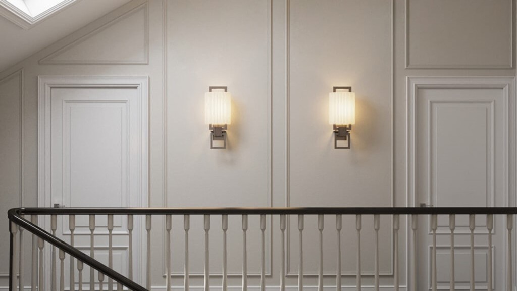 Interior of a listed building featuring classic architectural elements such as panelled walls, traditional wall sconces, and white doors. This image highlights the importance of preserving both internal and external features in a Grade II listed property. It emphasises the need for understanding the listing restrictions when considering alterations to historical interiors.