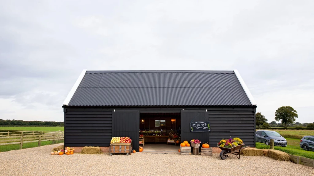 Black-clad farm shop in a converted agricultural building with fresh produce on display, illustrating a Class R commercial conversion.