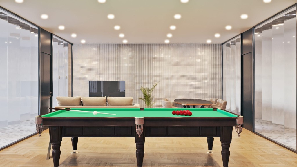 Sophisticated recreation room with a classic green billiard table, elegant lighting, and minimalist decor, flanked by floor-to-ceiling glass walls for a modern, open feel.