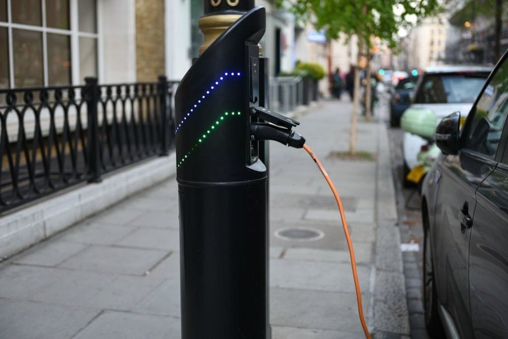 Electric vehicle charging station installed on a city street, symbolising the shift towards sustainable transportation and the decreasing demand for petrol stations. This image underscores the redevelopment potential of former petrol station sites for modern, eco-friendly uses such as housing.