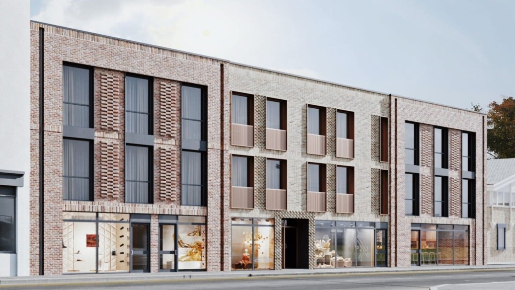 Modern residential building with contemporary brick facade and large windows, featuring ground-floor retail spaces. This urban redevelopment project incorporates sustainable design elements and seamlessly blends with the surrounding architecture, enhancing the area's aesthetic and functionality.