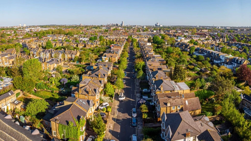 Aerial view of a London conservation area with tree-lined streets and rows of period houses, illustrating the sensitive historic context where flat amalgamation proposals are carefully controlled.