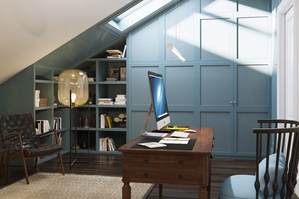 Loft conversion office with a large skylight naturally illuminating the customised and integrated wall mounted pale blue storage units, natural dark wood flooring with matching wooden desk and chairs
