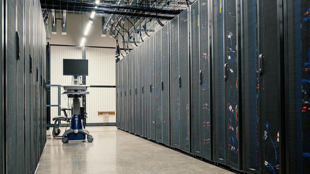 An interior view of a data centre featuring rows of server racks and advanced equipment, highlighting the technology that supports developments in Green Belt areas.