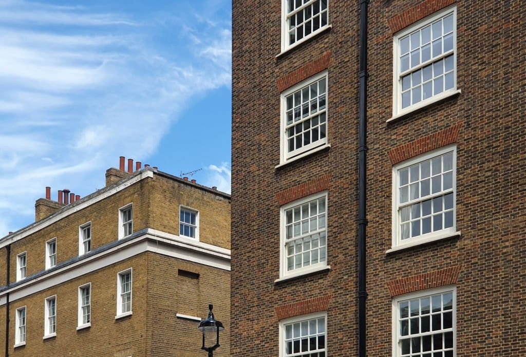 Upward view of london streeet properties with various brick types and colours