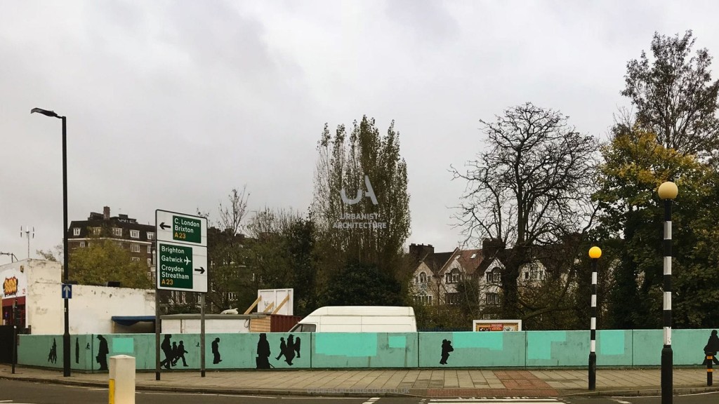 Empty urban development site in London with construction fencing displaying silhouettes, located at a busy intersection with directional signs pointing to Central London, Brixton, Brighton, Gatwick, Croydon, and Streatham.