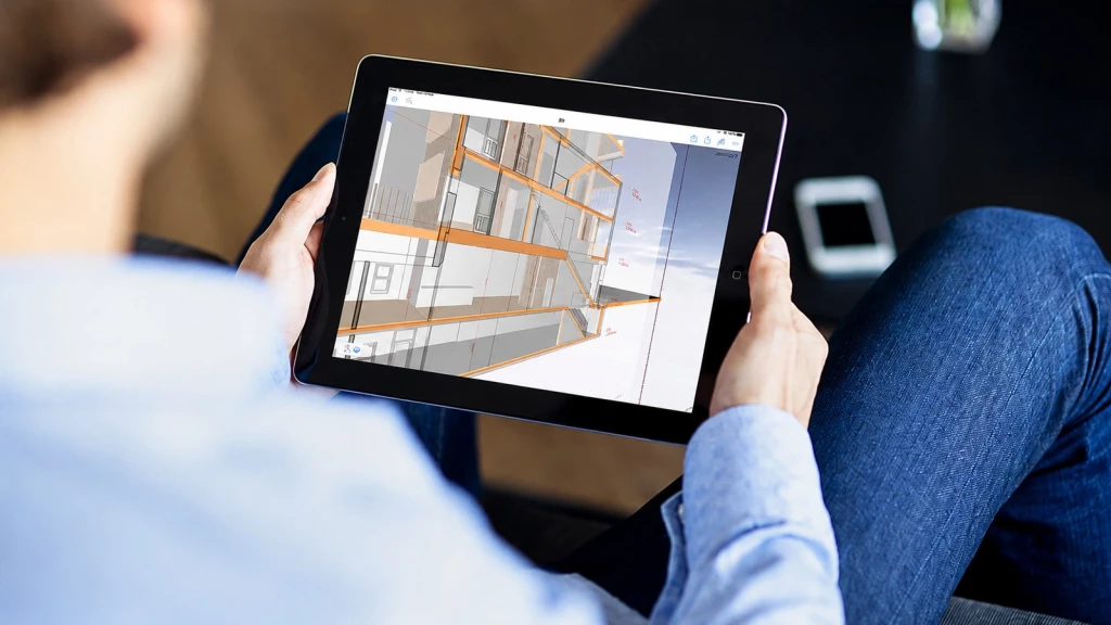 Homeowner reviewing a 3D BIM model on a tablet, visualising building design details and construction data for a residential extension, renovation or new build project before construction begins.