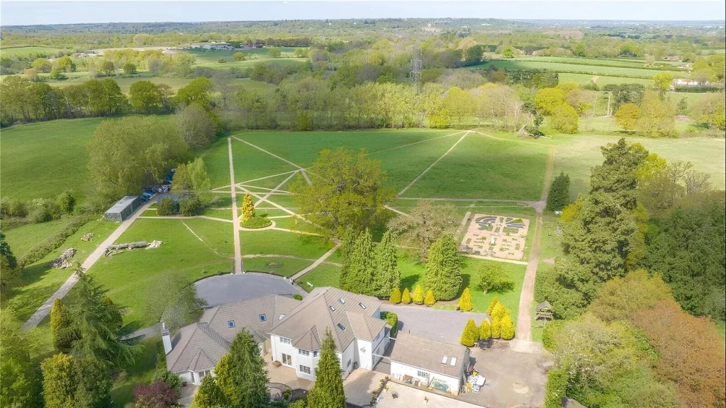 Large country house surrounded by landscaped gardens and open Green Belt countryside, illustrating a site with potential for sensitive development under evolving planning policy.