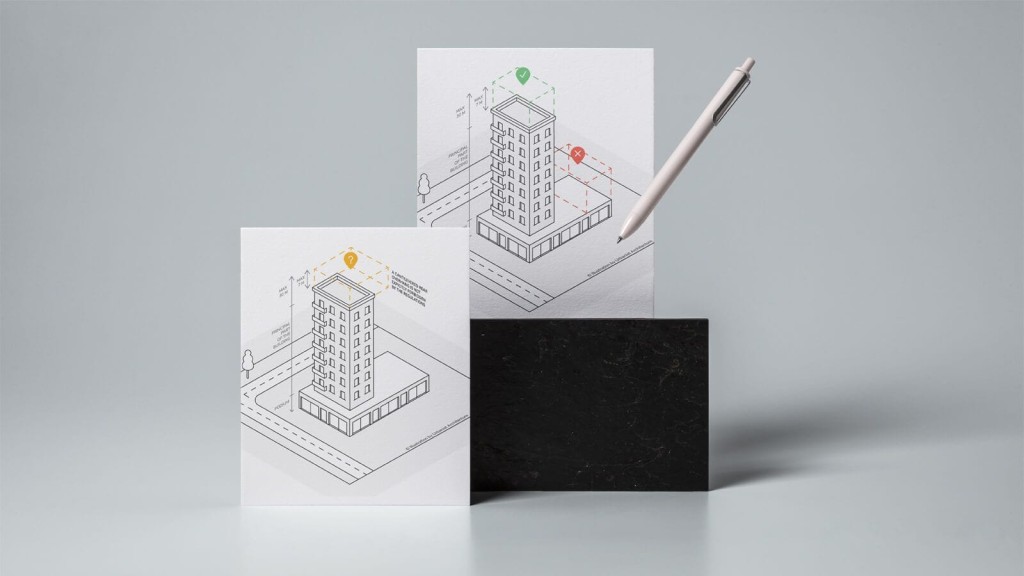 Conceptual presentation of urban development with two printed architectural drawings of a high-rise building, one showing a successful extension with a green checkmark and the other showing an error with a red cross, alongside a sleek white pen for annotation, all against a gray background with a black marble support.