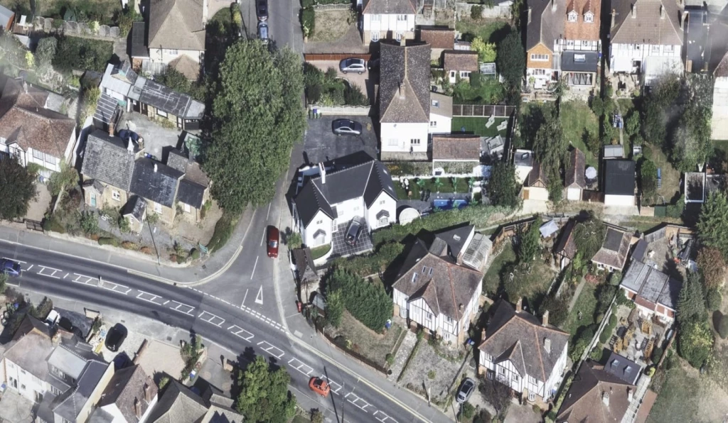 Aerial satellite view of the same detached property in London after a contemporary two-storey extension doubled the home from 79 sqm to 172 sqm, with the new rear and side additions clearly visible from above.