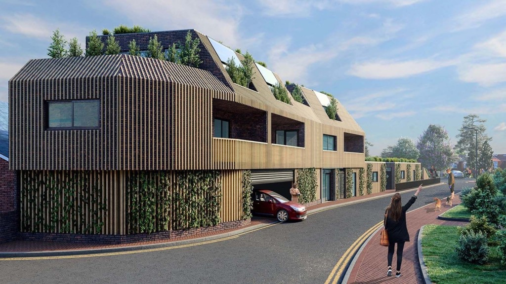 Modern eco-friendly housing development with green living roofs and vertical gardens on exterior walls, featuring a woman walking and a person parking a red car, promoting sustainable urban residential design.