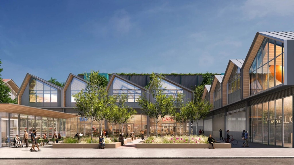 Modern design concept of a film studio in Buckinghamshire’s Green Belt, featuring glass-fronted buildings, greenery, and outdoor seating areas.