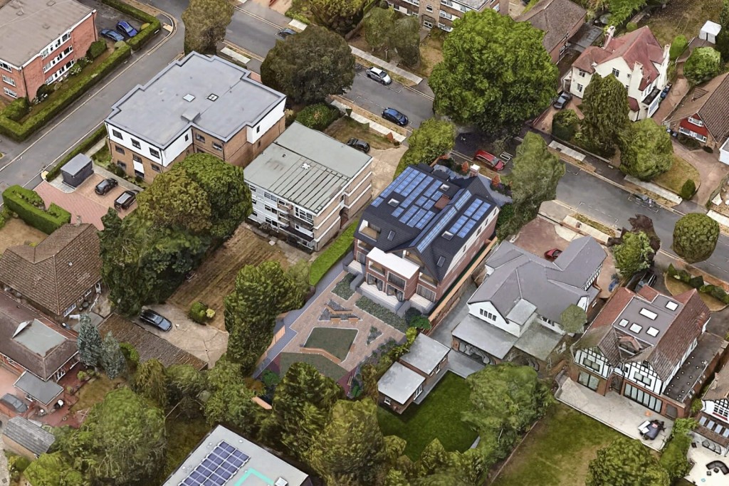 Aerial view of a residential neighborhood with a mix of houses, lush green trees, and solar panels on roofs, highlighting sustainable living in suburban development.