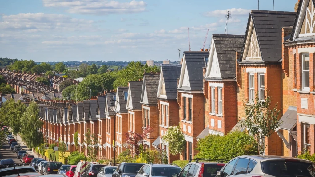 Rows of red-brick homes on a residential street in England, illustrating UK housing supply, development and the impact of government planning reform on housing delivery.