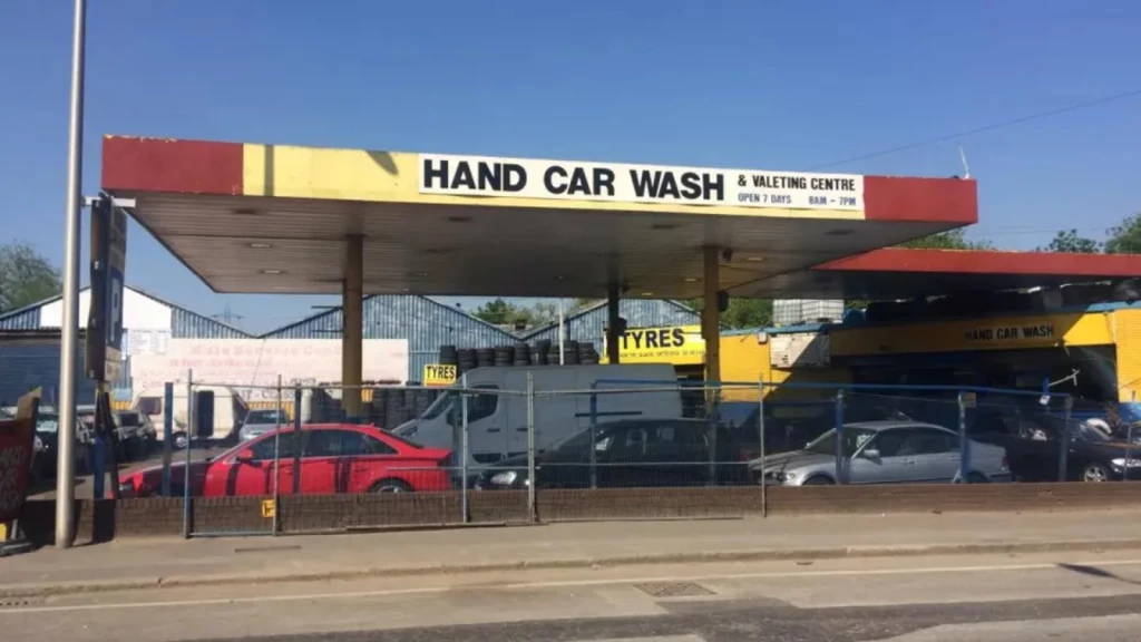 Hand car wash and valeting centre on Green Belt land near Tottenham Hale station, with cars, signage, and urban backdrop.