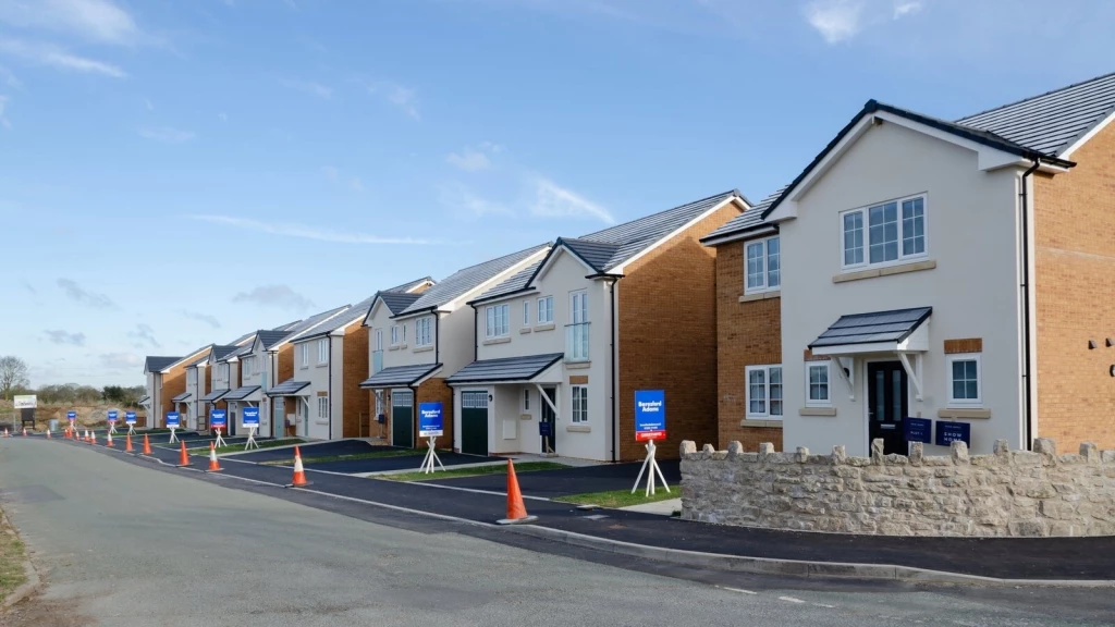 A row of newly built homes with marketing signs and cones, showcasing the tangible outcomes of successful Green Belt appeals.