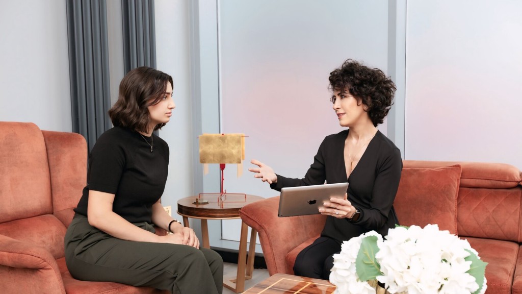 Two professionals discussing a project, with one holding a tablet, symbolising collaboration and preparation for submitting successful Green Belt appeals