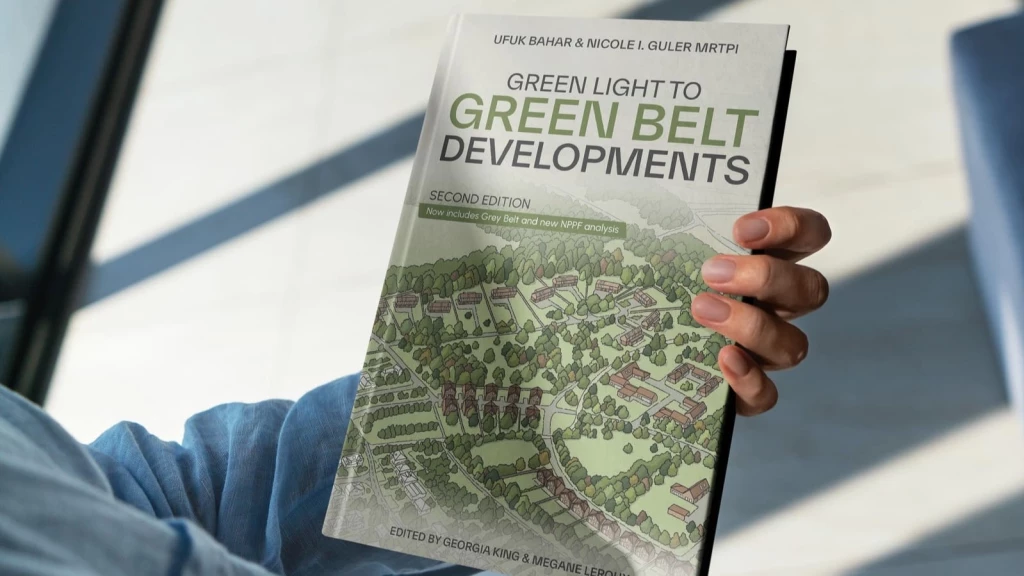 A person holding a book titled "Green Light to Green Belt Developments," written by Ufuk Bahar and Nicole I. Guler MRTPI. The book cover features a design of modern housing set against a backdrop of trees, symbolising development within Green Belt land. This image is ideal for promoting discussions around Green Belt policy, sustainable housing developments, and urban planning. Perfect for those seeking insights into navigating the complexities of Green Belt rules, key purposes, and planning permission processes.