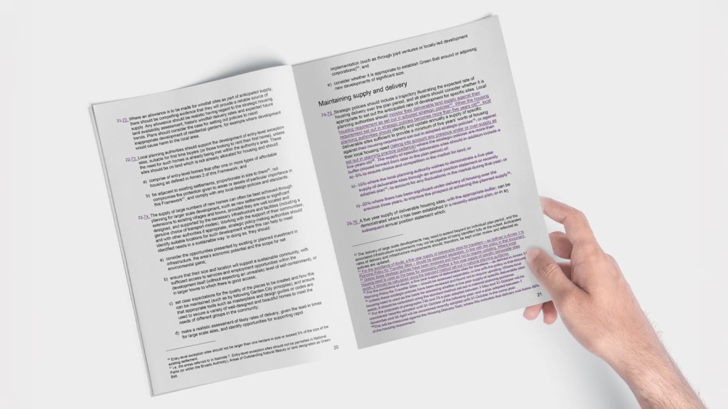 Close-up view of a person's hand holding an open book or document, highlighting updated text related to Green Belt planning policy and NPPF changes. The pages feature detailed information, with certain sections underlined or highlighted in purple, emphasising key points about maintaining supply and delivery in urban planning. This image represents recent updates to the National Planning Policy Framework (NPPF) and Green Belt rules, relevant for planners, developers, and policy professionals.