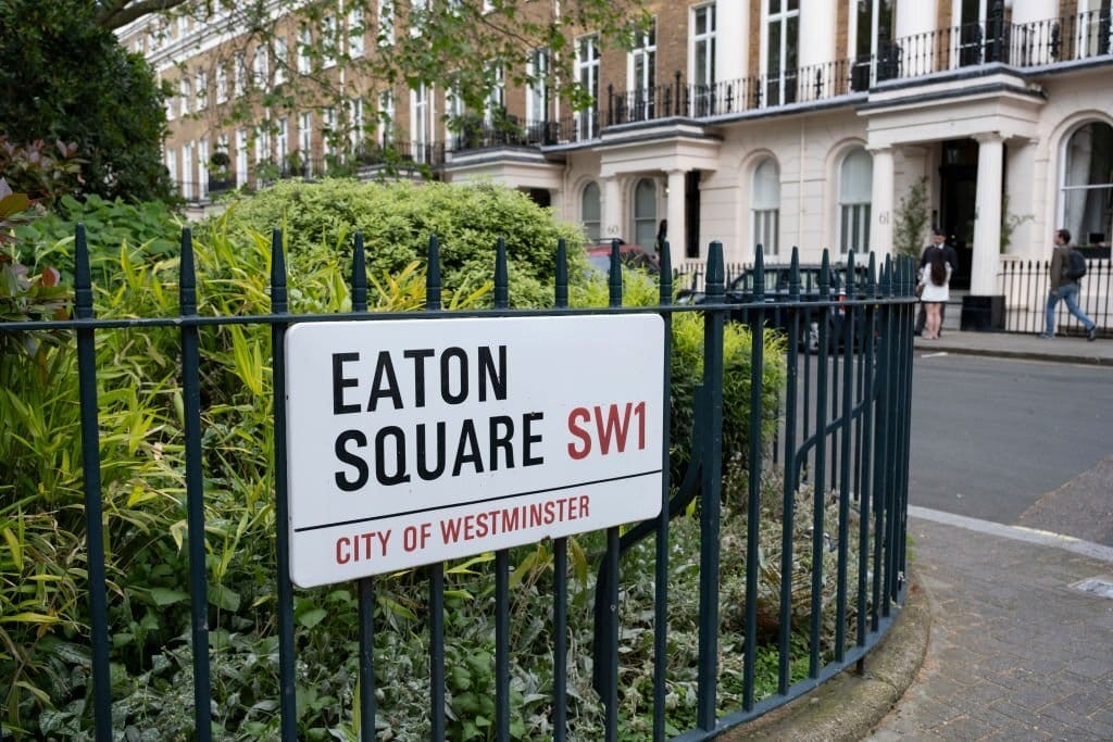 Sign indicating Eaton Square in the City of Westminster (SW1) attached to the green gates of a private garden to its local residents