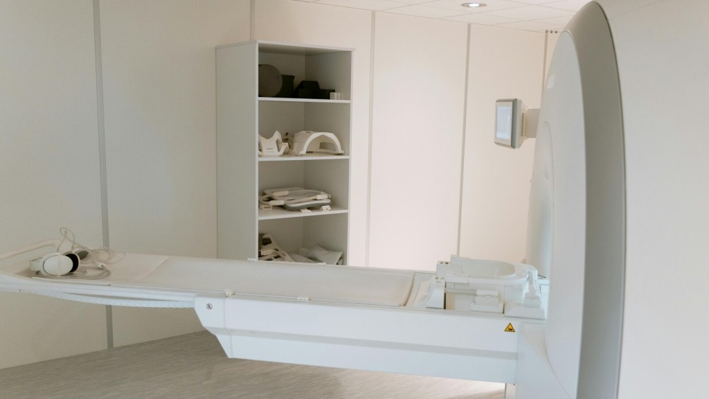 MRI room in a healthcare facility with modern, clean design emphasising safety and efficiency. The minimalistic white interior features a medical imaging machine, ergonomic layout, and shelves for storage, reflecting principles of infection control, patient comfort, and operational efficiency in healthcare architecture.