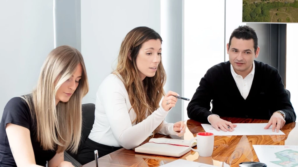 Architects and planning consultants discussing HMO planning application strategies and compliance requirements.