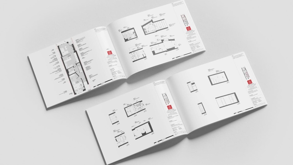 Open architectural design plans displayed in a professional booklet, featuring detailed layouts and measurements, essential for planning seamless house extensions and ensuring compliance with UK interior architecture standards.