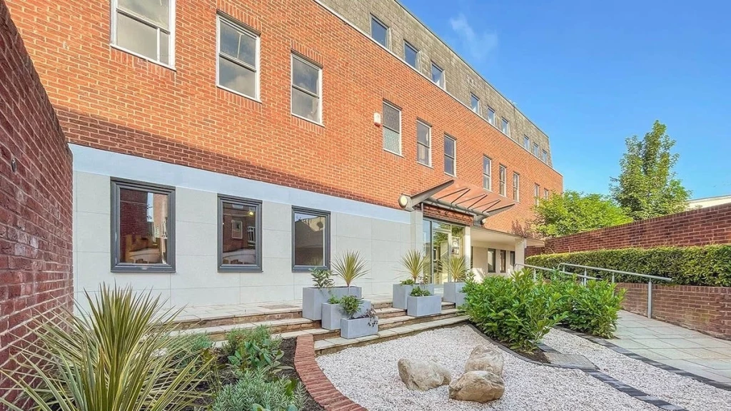 Paxton House in London, viewed from the exterior entrance and small landscaped courtyard, showing a modern office to residential conversion.