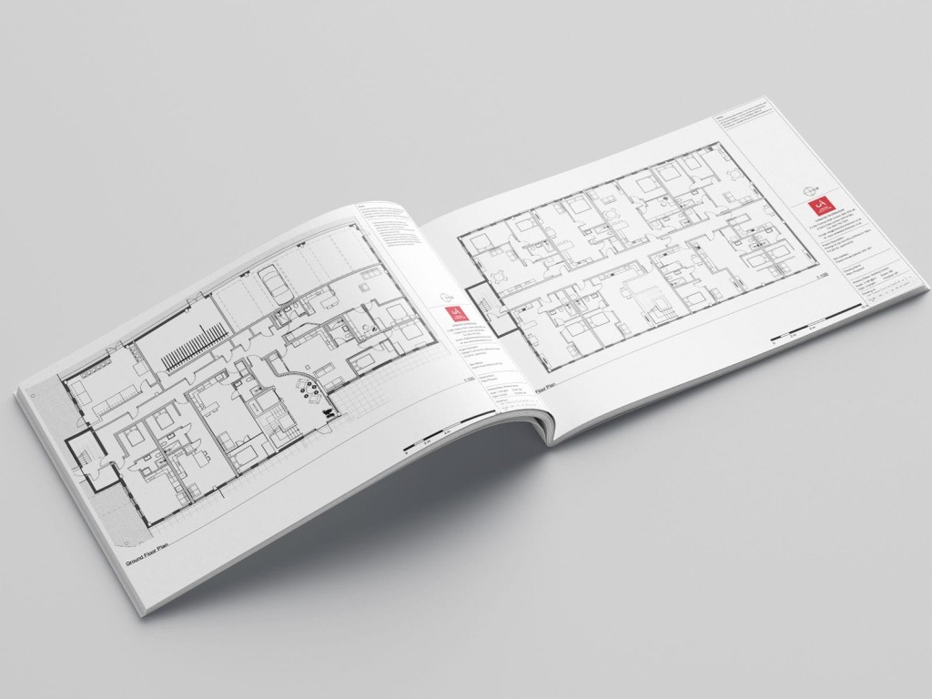 Open magazine featuring detailed architectural floor plans for office conversion into homes, with annotations and scale measurements, laid on a neutral surface, showcasing modern space planning for residential use.