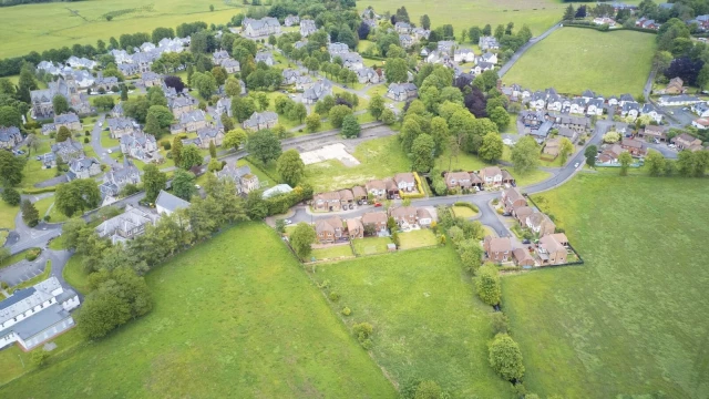 Image cover for the article: Aerial view of a newly development neighbourhood, alongside another portion of development currently underway in construction, surroudning by green fields and sparsed out dwellings