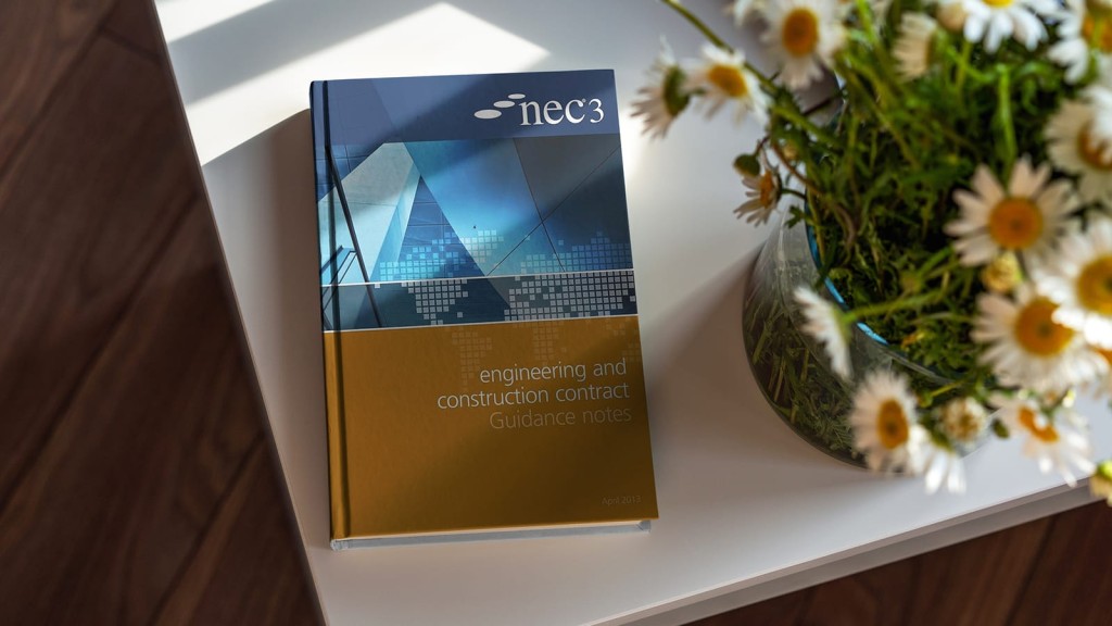 NEC3 Engineering and Construction Contract Guidance Notes book on a white table beside a vase of fresh daisies, highlighting the integration of project management literature with natural office decor.
