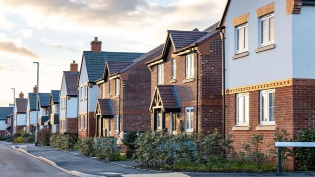 A row of new-build suburban homes illustrates the gap between promise and delivery one year on with Labour in charge and the challenges of implementing housing reforms and the new Grey Belt policy.