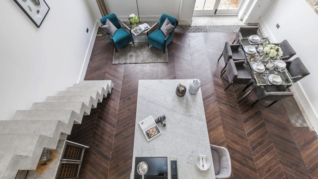 A captivating aerial perspective of a meticulously crafted living room with a dining table, exemplifying the exquisite design expertise of our RIBA chartered architectural and planning firm in London.