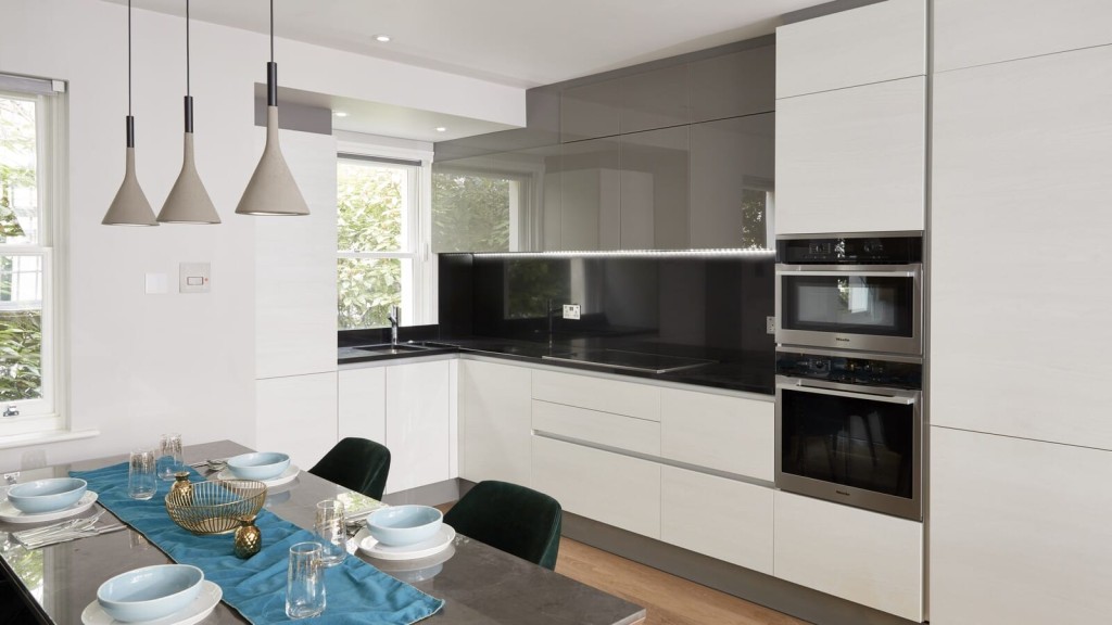 Contemporary kitchen design by a Central London architectural firm, featuring stylish dining table and chairs for a seamless blend of functionality and aesthetic appeal.