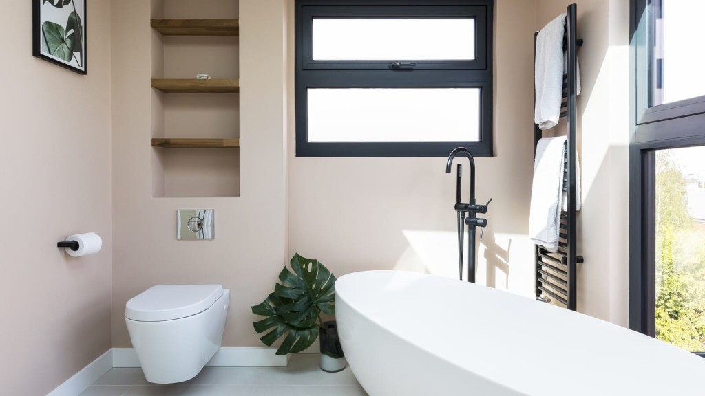 Discover the exquisite craftsmanship of RIBA chartered architects in this beautifully designed bathroom featuring a pristine white bathtub and expansive window, ideal for natural light and relaxation.