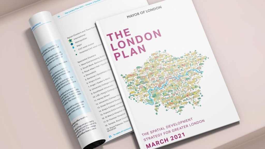 The open pages of 'The London Plan March 2021' report revealing detailed urban planning text and a colorful map, representing the spatial development strategy for Greater London, set against a minimalistic backdrop.