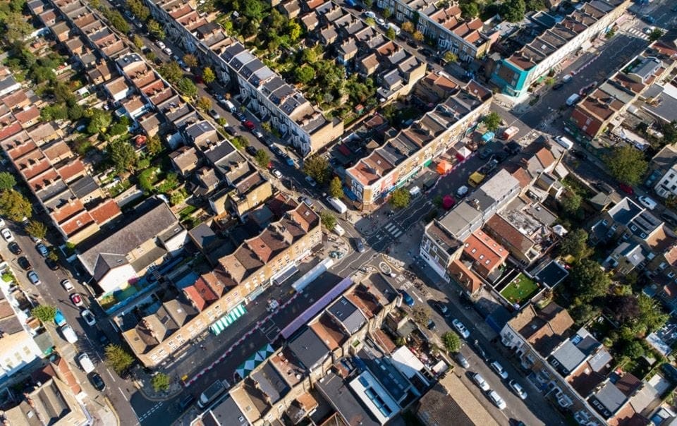 Aerial view of a UK town, illustrating the dense layout of homes and commercial properties, symbolising the impact of new Permitted Development Rights on high streets and housing quality.