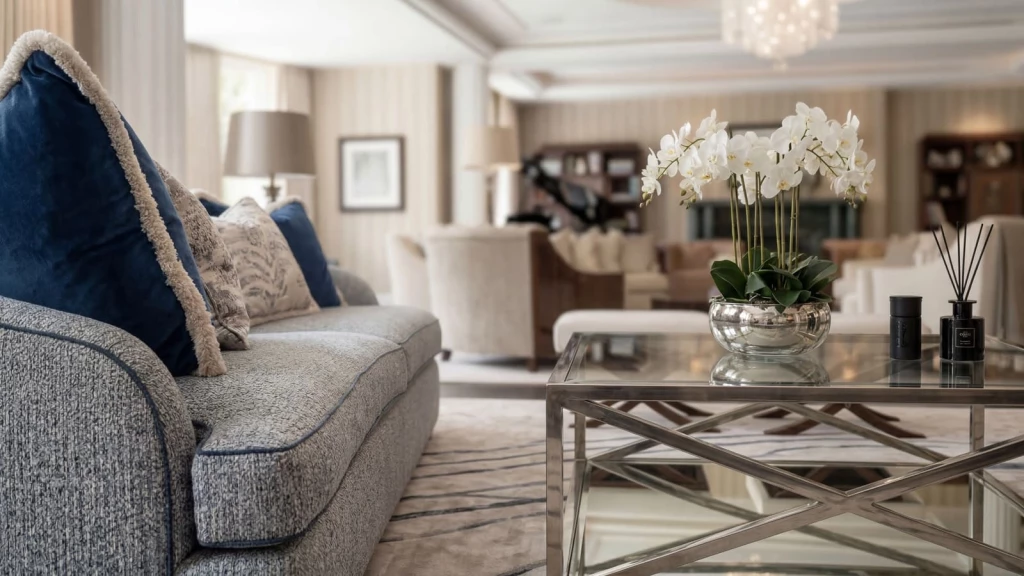 Refined neutral living room with marble coffee table and curved seating, comparing old money and English country interiors.