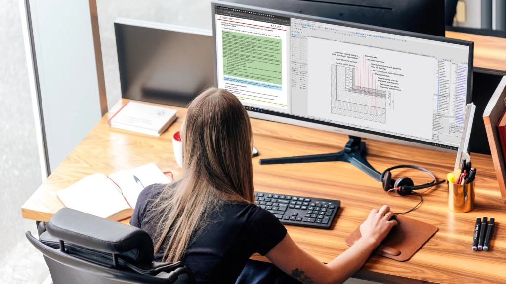 Interior architect reviewing technical drawings and construction details on CAD software for residential renovation and luxury home design project.