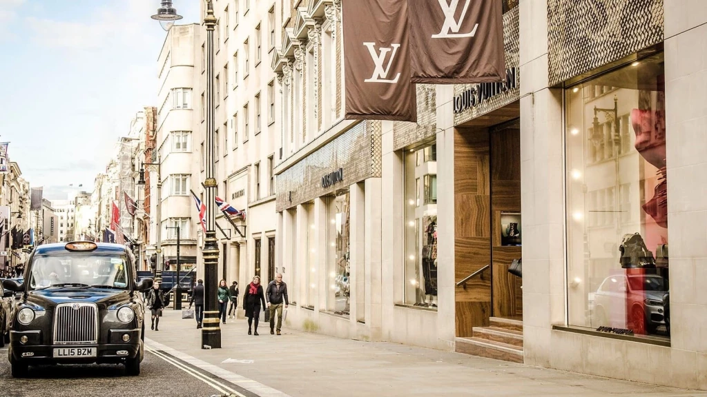 Luxury fashion boutiques on a London high street with designer storefronts, reflecting old money style, quiet luxury and high-end lifestyle aesthetic.