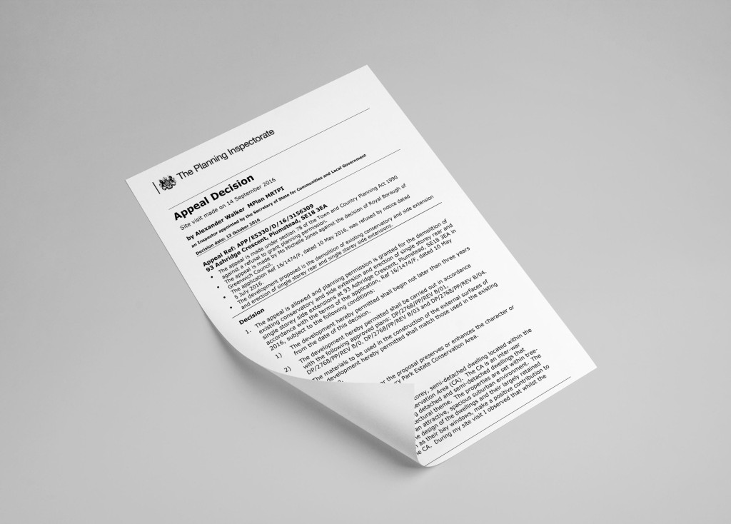 A single page titled 'Appeal Decision' from The Planning Inspectorate resting on a gray surface, illustrating an essential document involved in the legal procedures of planning appeals, indicative of regulatory processes in urban development.