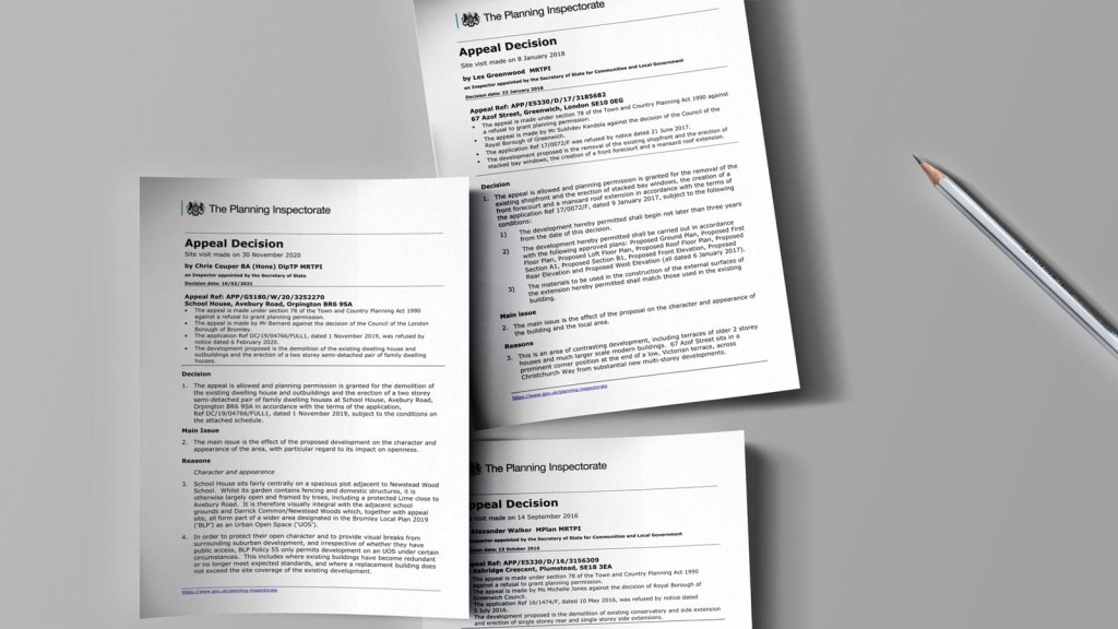 Three documents titled 'Appeal Decision' by The Planning Inspectorate, spread out on a gray surface, detailing the outcomes of various planning appeals with specific site and decision references visible, accompanied by a pencil, symbolising precise legal and regulatory work in town planning.