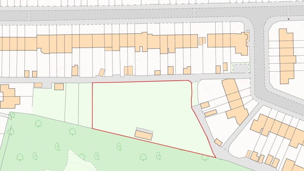 Detailed zoning plan displaying a vacant plot outlined in red, surrounded by residential buildings, with adjacent streets and green spaces indicated, illustrating a potential development area for urban planning and architectural design projects.